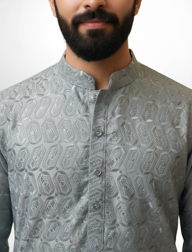 Man wearing a gray patterned shirt against a white background