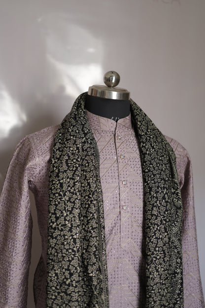 Close-up of a folded fabric with floral pattern and purple border on a white background