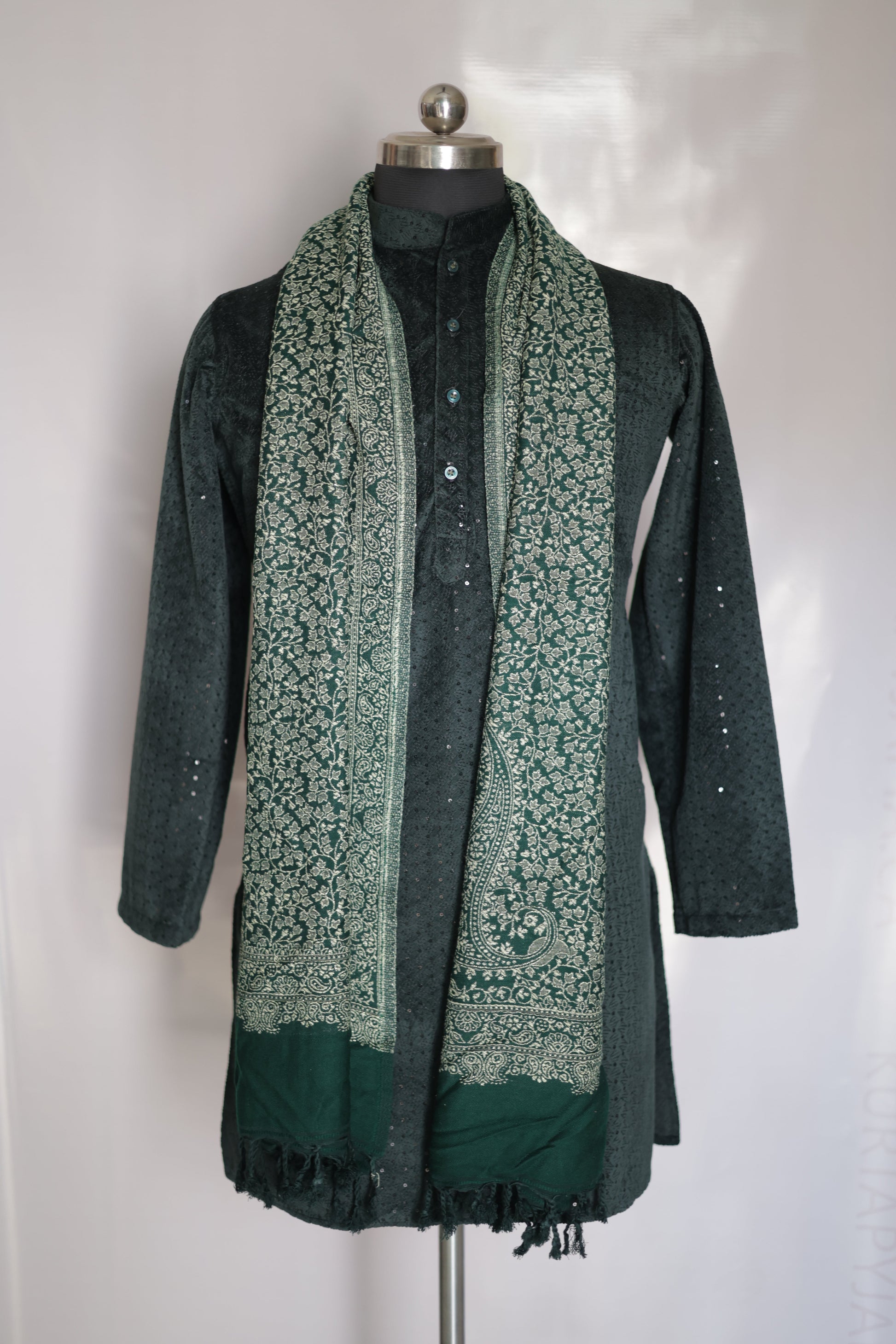 Green patterned bag with a metallic clasp on a white background