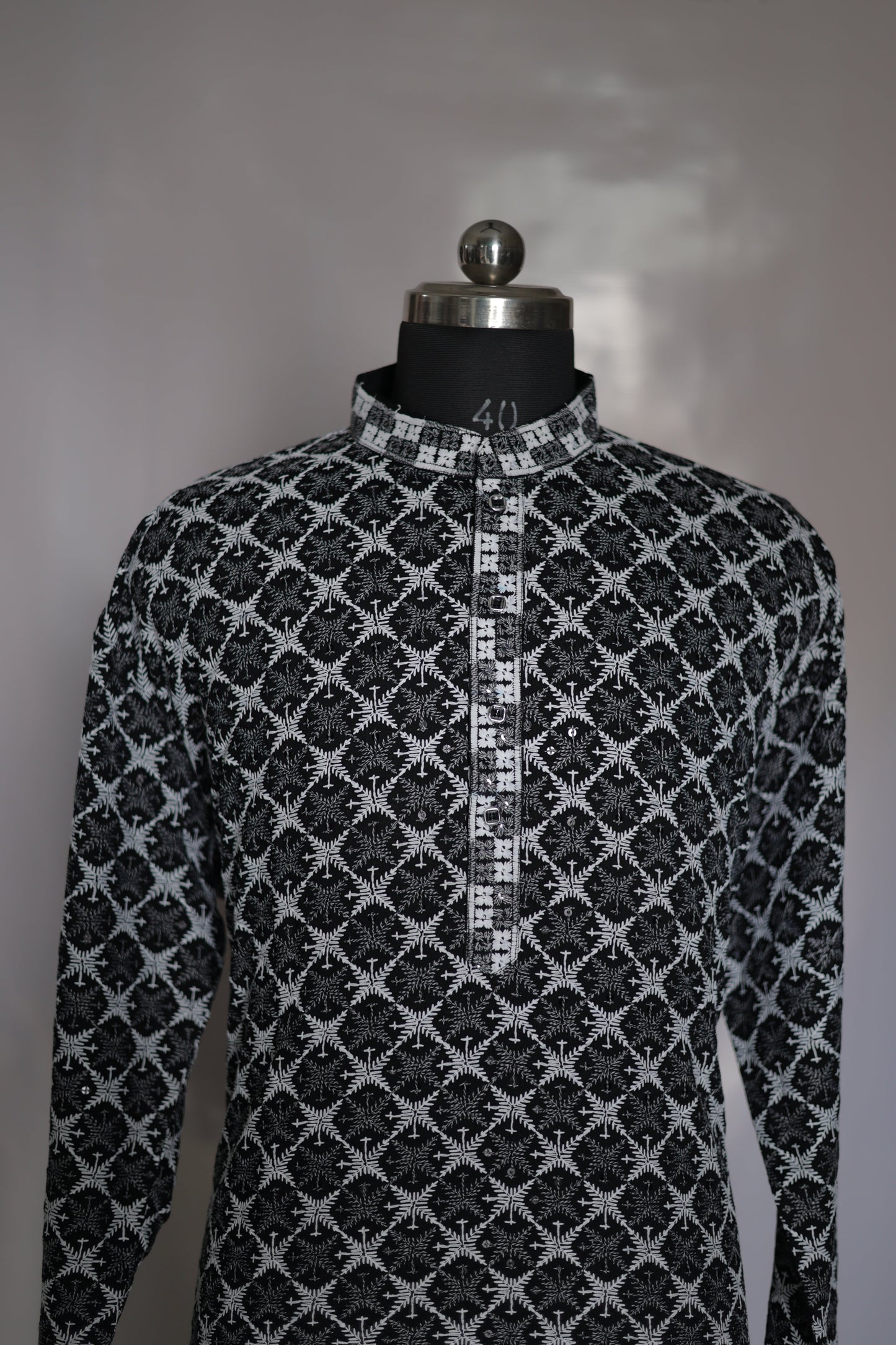 Black and white patterned fabric on a mannequin with a plain background