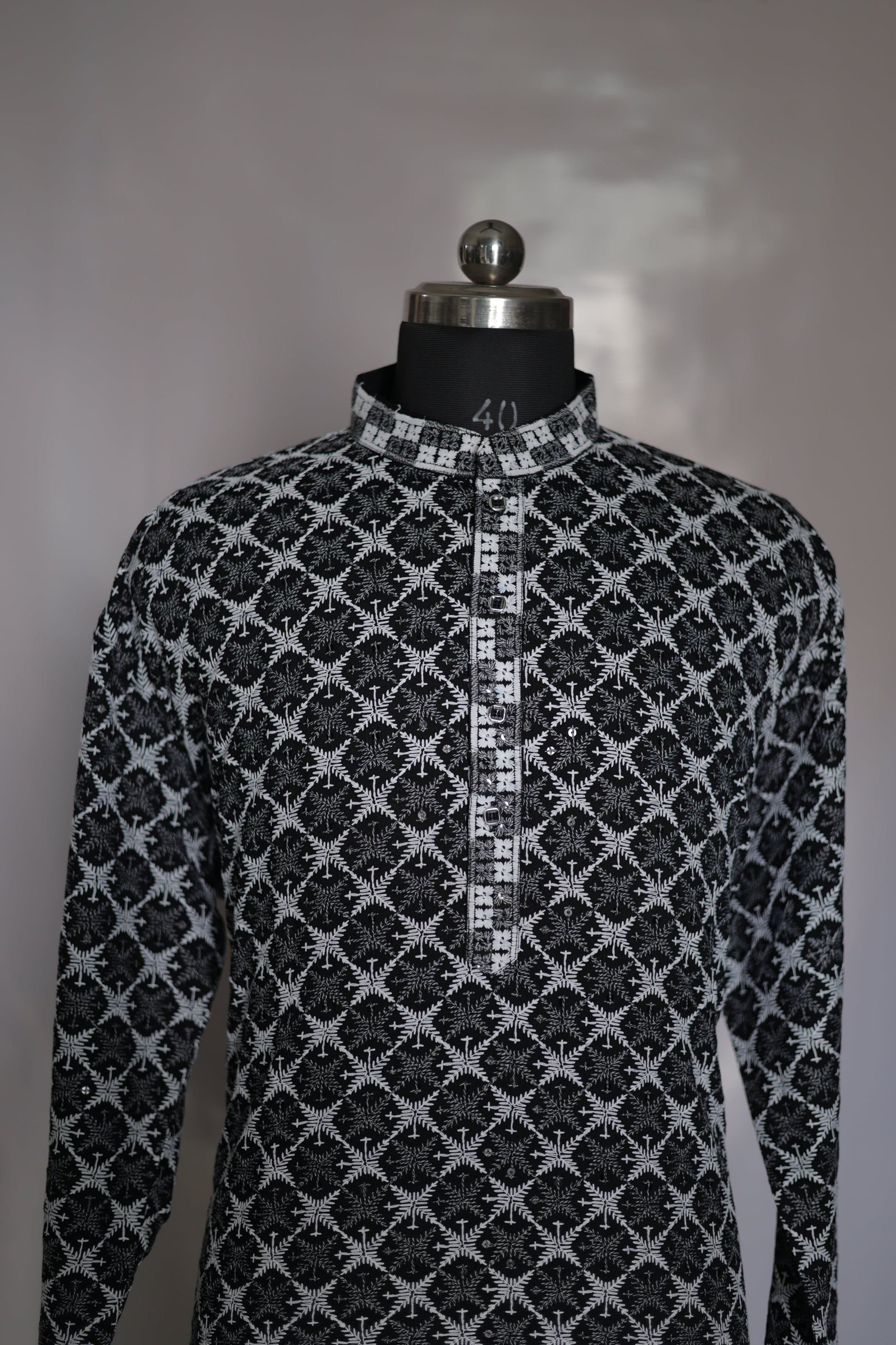 Black and white patterned fabric on a mannequin with a plain background