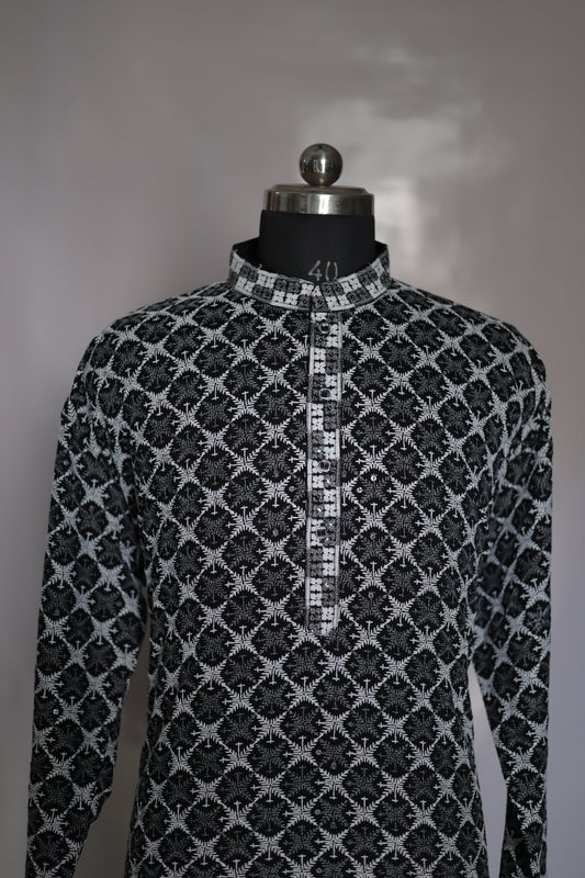 Black and white patterned fabric on a mannequin with a plain background