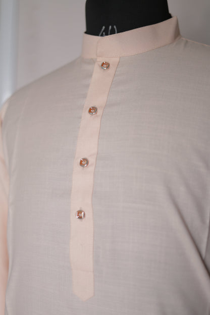 Close-up of a beige belt with decorative elements on a light gray background