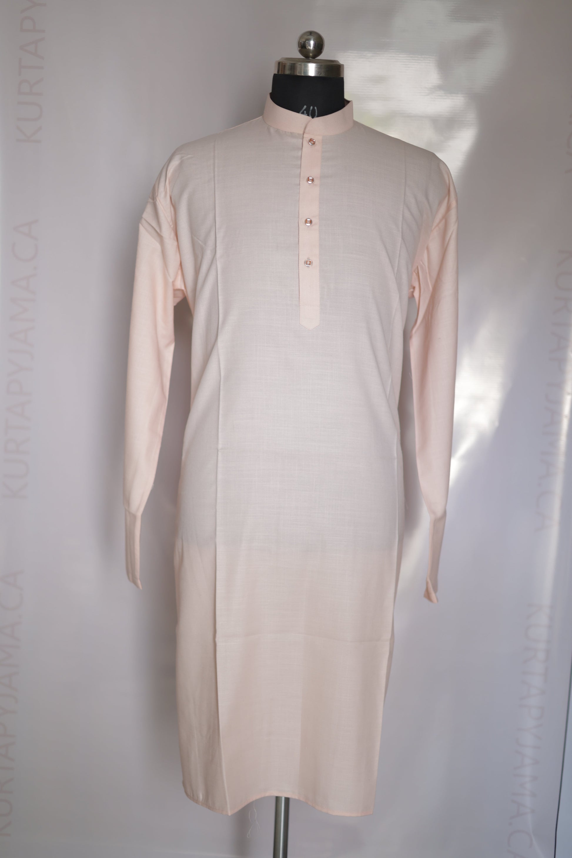 Mannequin wearing a light pink dress on a white background