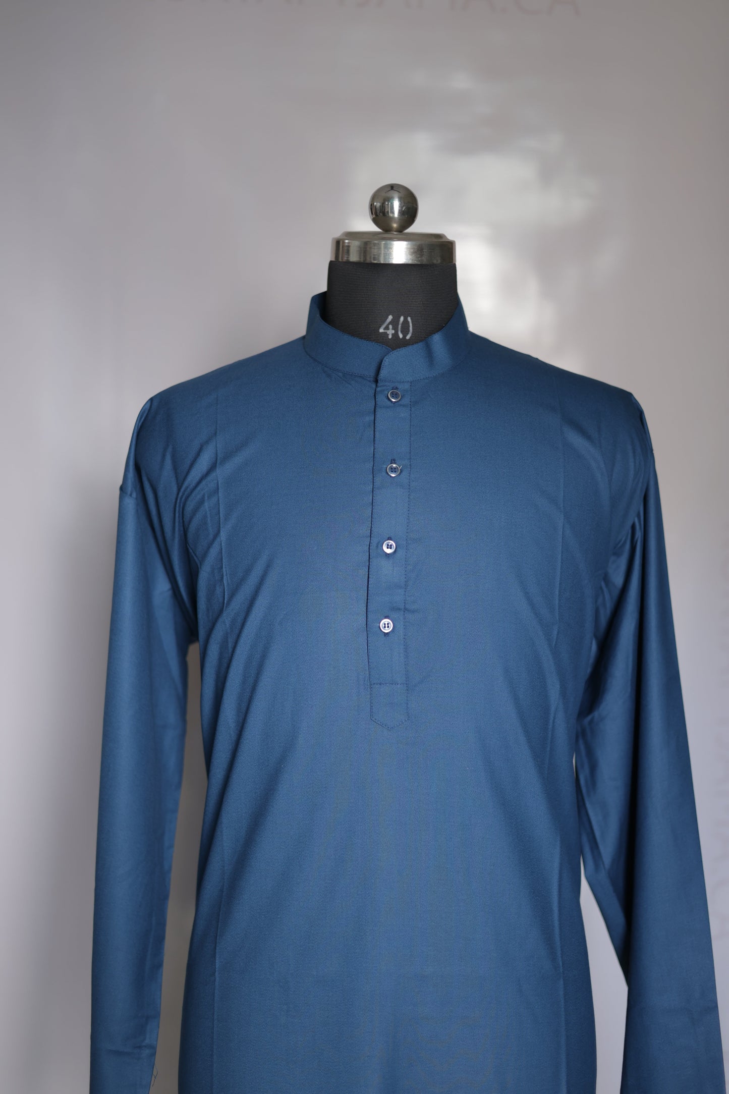 Blue shirt on a mannequin with a plain background