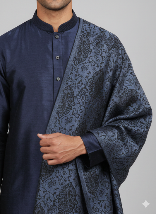 Man wearing a navy kurta with a patterned shawl over his shoulder on a gray background