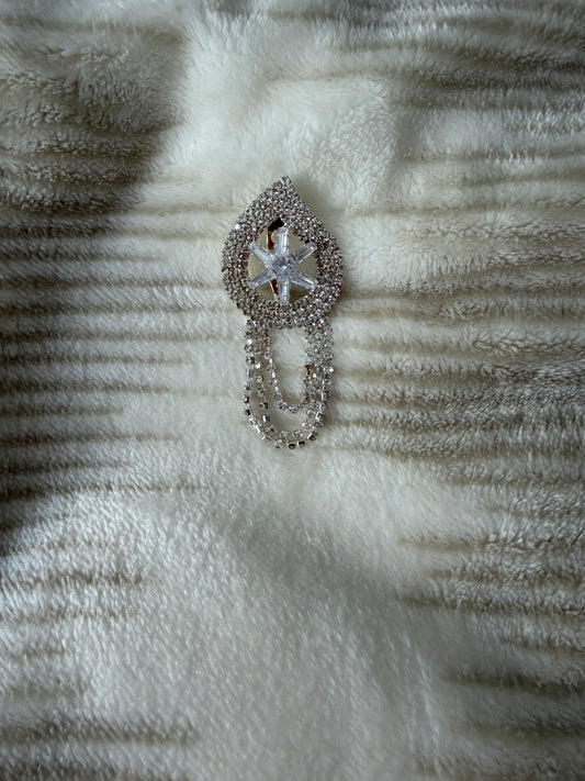 Decorative brooch with star design on a textured fabric background